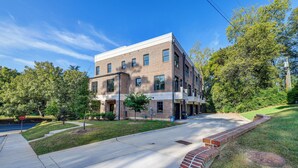 A two-story building with a brick facade, a flat roof, and a sidewalk in front.