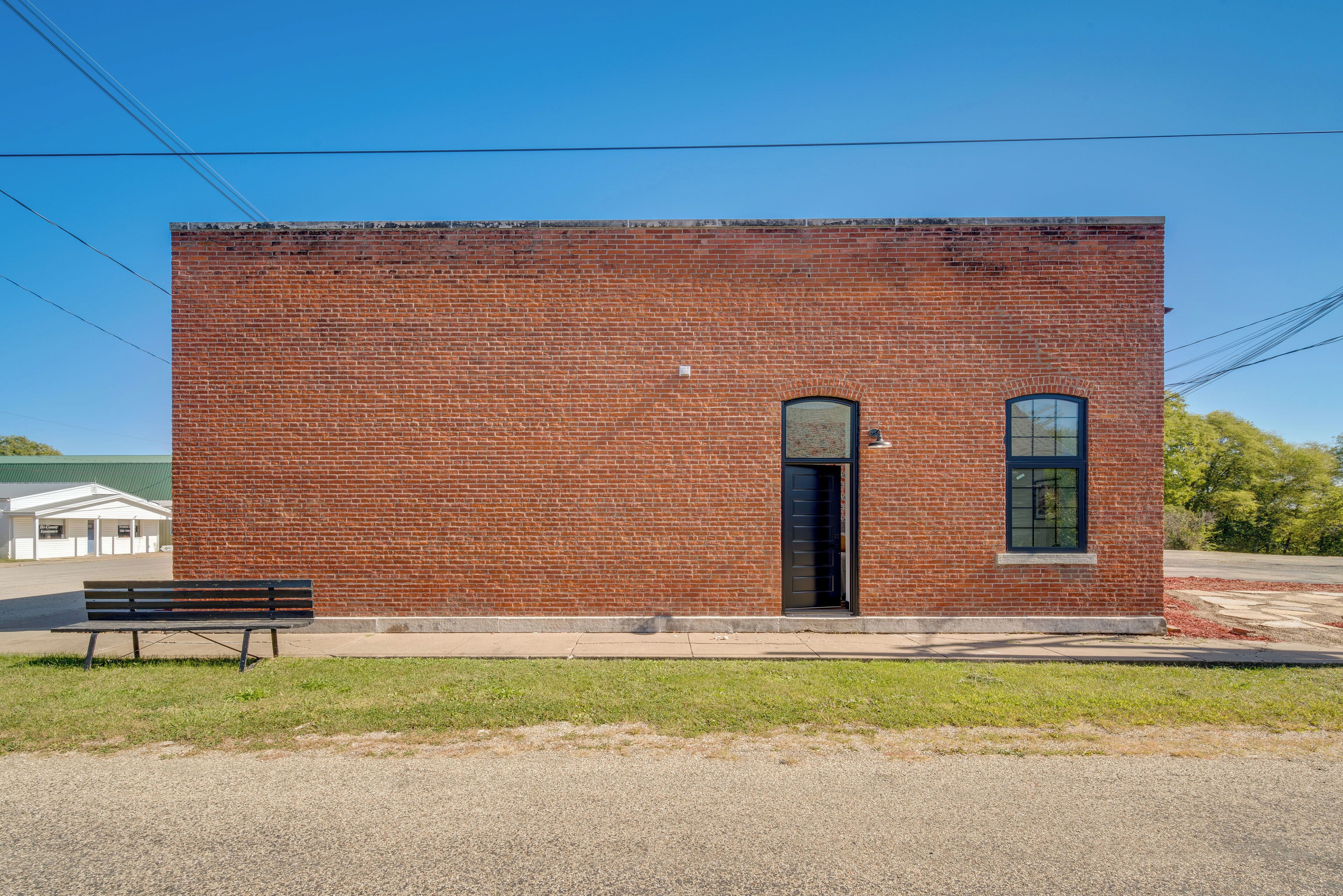 A small brick building with a door and a window.