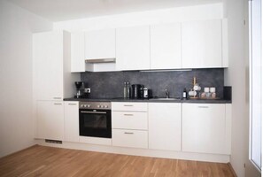 Apartamento | Cozinha privada | Geladeira, fogão, cooktop, máquina de café expresso