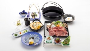 A variety of Japanese dishes including sashimi, a pot, a bowl of soup, and a plate of meat. - Hotel Sumire (Shimonoseki)