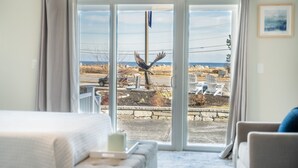 A room with a large sliding glass door leading to a patio area. - 935 Ocean A Beachside Inn (Hampton)