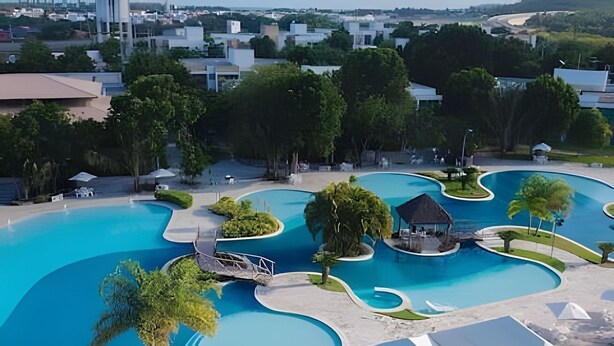 A large swimming pool with multiple sections and a small hut. - Iloa Residence Resort Para 4 Pessoas by MME (Barra de São Miguel)