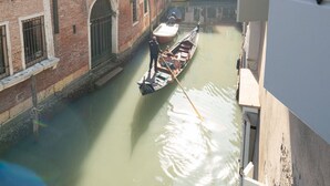 A narrow canal with gondolas, surrounded by historic buildings with arched windows and brick facades. - San Marco Style Canal View Apt. 2 by Wonderful Italy (Venecia)