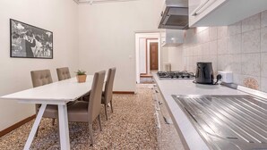 A modern kitchen with a gas stove, a coffee maker, and a chandelier. - Venice Luxury Palace 6 by Wonderful Italy (Venecia)