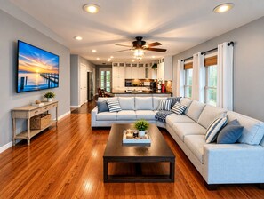A modern living room with a sectional sofa, a coffee table, and a TV mounted on the wall. - Oneida Lake Oasis (Bridgeport)