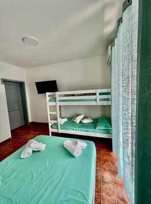 Cozy retreat with a bunk bed arrangement, featuring a flat-screen TV and comfortable bedding.