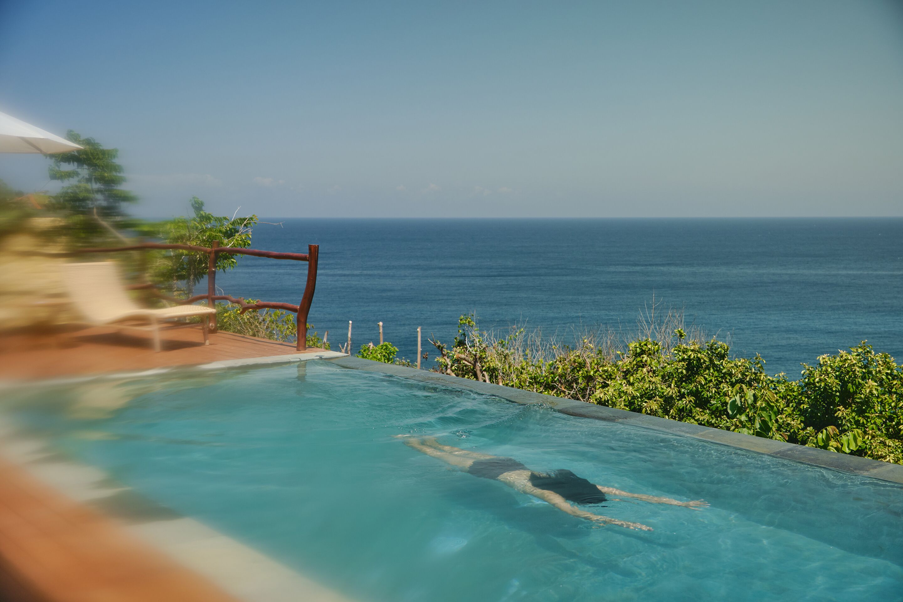 A swimming pool with a view of the ocean.
