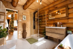 A wooden interior with a bathroom, a mirror, and a sink. - Welcome to the Jungle | Log cabine | Spa (Saint-Philémon)