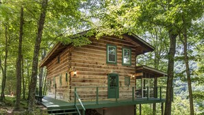 A log cabin with a wooden exterior, green accents, and a porch. - Grandpa Dans Cabin+Mtn River view 34 acre retreat (Marshall)