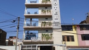 A multi-story hotel with balconies and a sign that reads "HOTEL BRACE". - Terrazas Suite (Lima)