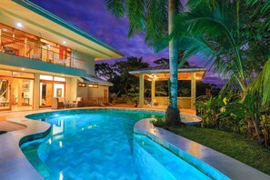 A two-story house with a swimming pool, outdoor seating, and a covered patio area. - Rainforest Estate by Pura Villas (Quepos)