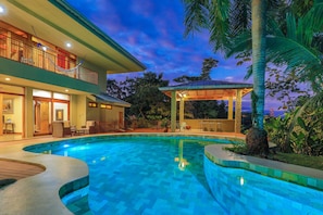 A two-story house with a swimming pool, outdoor seating, and a covered patio. - Rainforest Estate by Pura Villas (Quepos)