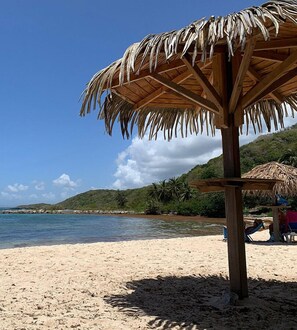 Relax under a shaded haven amidst lush greenery and ocean views.