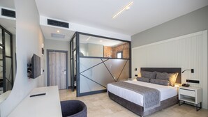 A modern bedroom with a bed, bedside table, and a mirror.