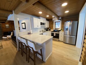 Fridge, microwave, oven, stovetop - Lakefront cabin with dock, hot tub, fire pit!! (Plymouth)