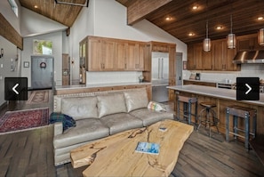 A modern kitchen with wooden cabinets, stainless steel appliances, and a central island.