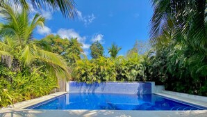 A pool with wooden loungers and a tiled wall. - Villa Tortolas 5 Min Walk To La Ropa Beach (Zihuatanejo)