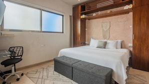 A bedroom with a bed, a desk, and a chair. - Elegant private room by a pool (Isla Mujeres)