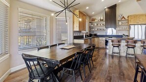 A modern kitchen with a central island, wooden flooring, and built-in cabinetry. - Spectacular Mountain Oasis (Eden)