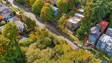 An aerial view of a residential area with houses, streets, and trees.