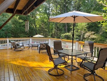 The deck is 600+ sq ft & includes varied seating, gas grill, + firepit table.