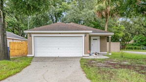 A single-story house with a garage, a front porch, and a driveway leading to the garage. - Huge backyard and new reconstruction  (St. Augustine)