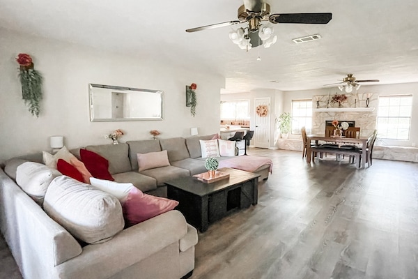 Jumbo couch and open concept floor plan with views of dining and kitchen.