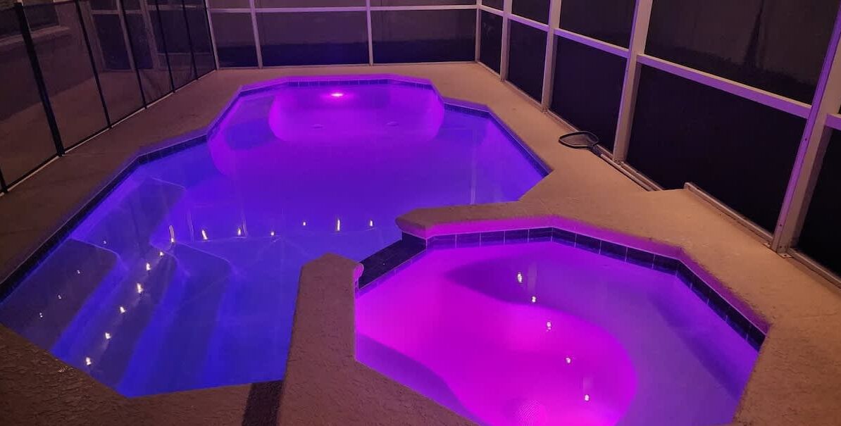 A hot tub area with a tiled floor and a glass enclosure.