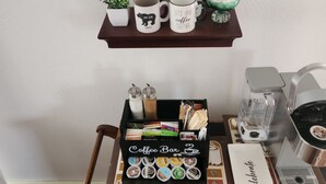 A coffee station with a coffee bar, a coffee machine, and a mug rack. - Home Away from home, fully/equipped, nearJBER, private parking <4 miles Downtown (Anchorage)