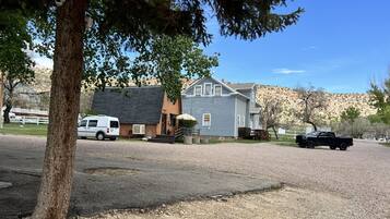 A residential area with houses, a driveway, and a gravel path.