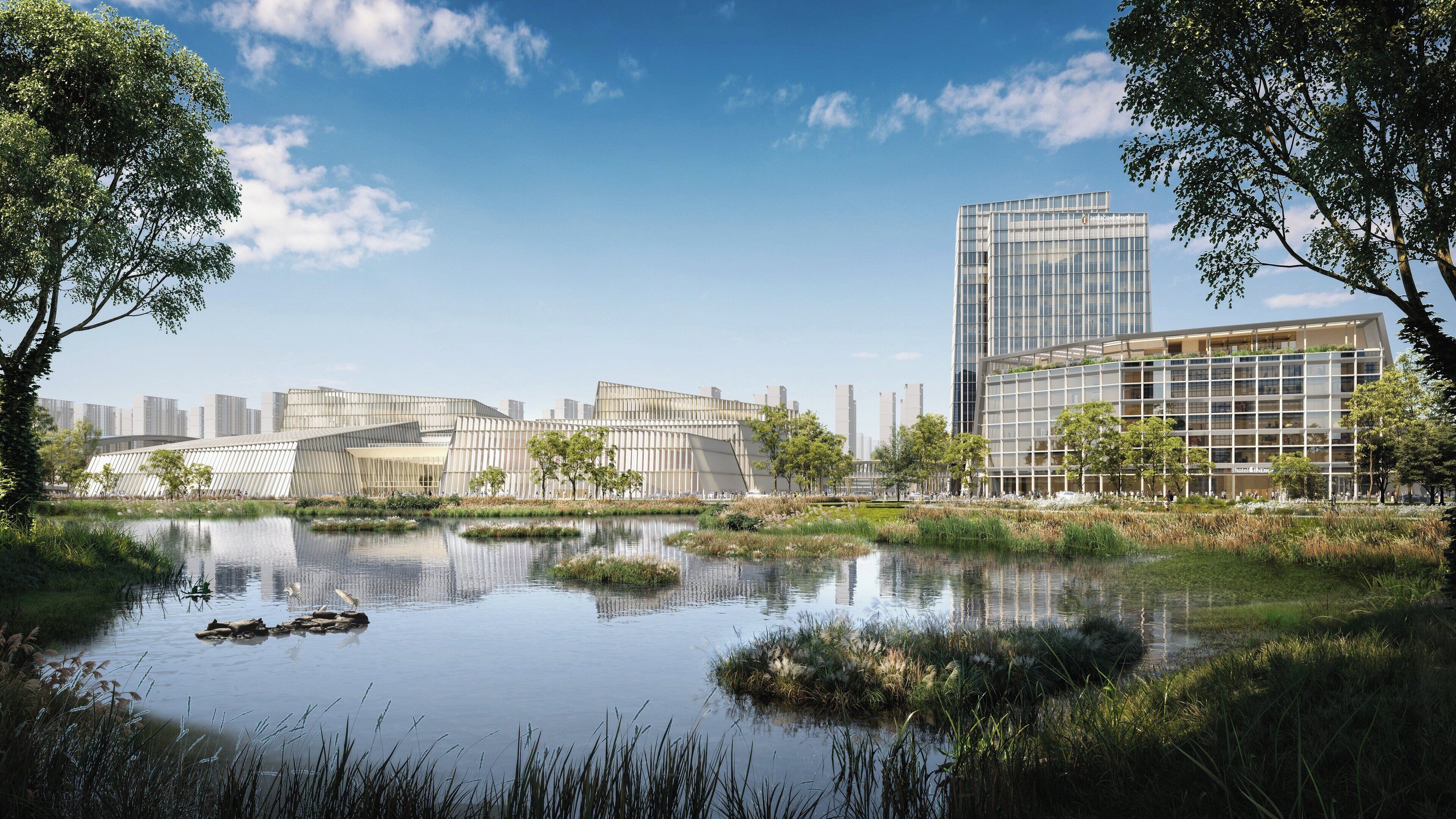 A modern hotel with a glass facade, surrounded by a tranquil pond and greenery.