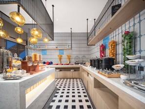 A modern kitchen with a checkered floor, stainless steel appliances, and a variety of food items displayed on the counter. - Holiday Inn Express Shanghai Hongqiao Linkong by IHG (Shanghai)