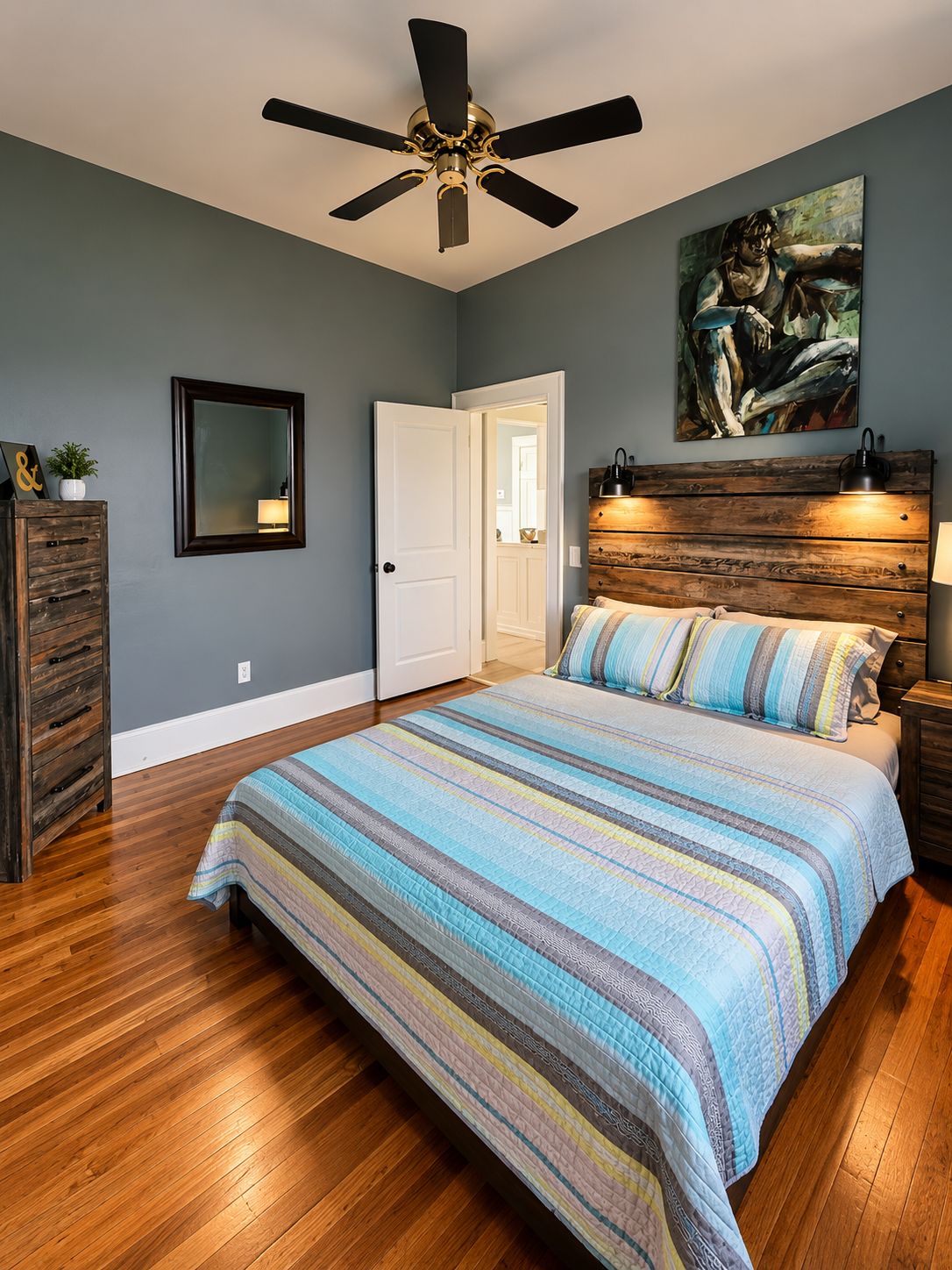 A bedroom with a bed, a ceiling fan, a wooden headboard, a painting, and a dresser.