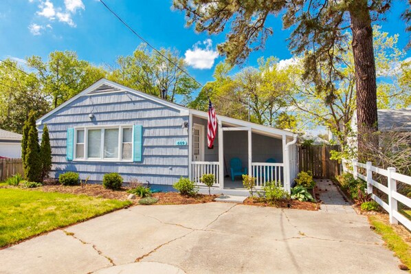 A single-story house with a porch, a mailbox, and a small front yard.