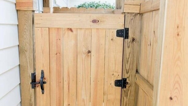 A wooden pergola structure with a wooden gate. - North End Paradise - North End VB (Virginia Beach)