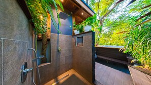 Enjoy a refreshing shower with a view of lush greenery from the seat.