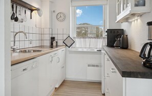 Fridge, stovetop, dishwasher, coffee/tea maker