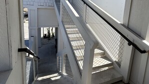 A staircase with a metal railing leading to a covered area with a tiled roof. - Stay in the top 2 floors of the brand new Silo Inn, near Zion!  (Washington)