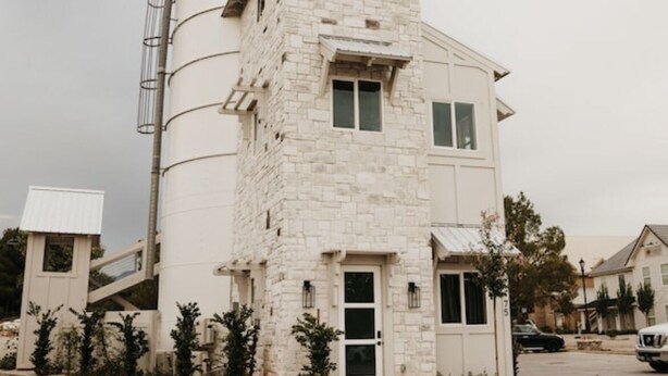 A multi-story building with a stone facade, a central entrance, and a silo structure to the left. - Stay in the top 2 floors of the brand new Silo Inn, near Zion!  (Washington)
