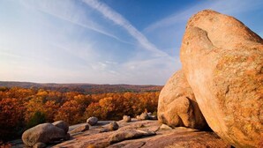 A large rock formation with a clear sky and autumn foliage in the background. - Black River Motel and Restaurant (Lesterville)