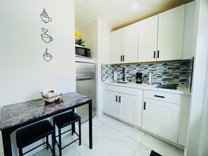 Fridge, microwave, stovetop, coffee/tea maker