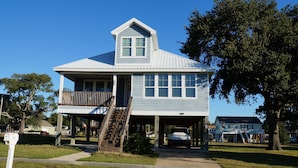 A two-story house with a covered garage and a front porch.
