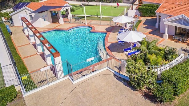 A residential property with a swimming pool, outdoor seating, and a tennis court. - Breakers 1/10- Stone Real Estate Yamba (Yamba)