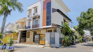A modern two-story building with a flat roof, large windows, and a visible sign for 'OYO LIFE'. - OYO Life 2760 Kost Simpang Borobudur 47 (Malang)