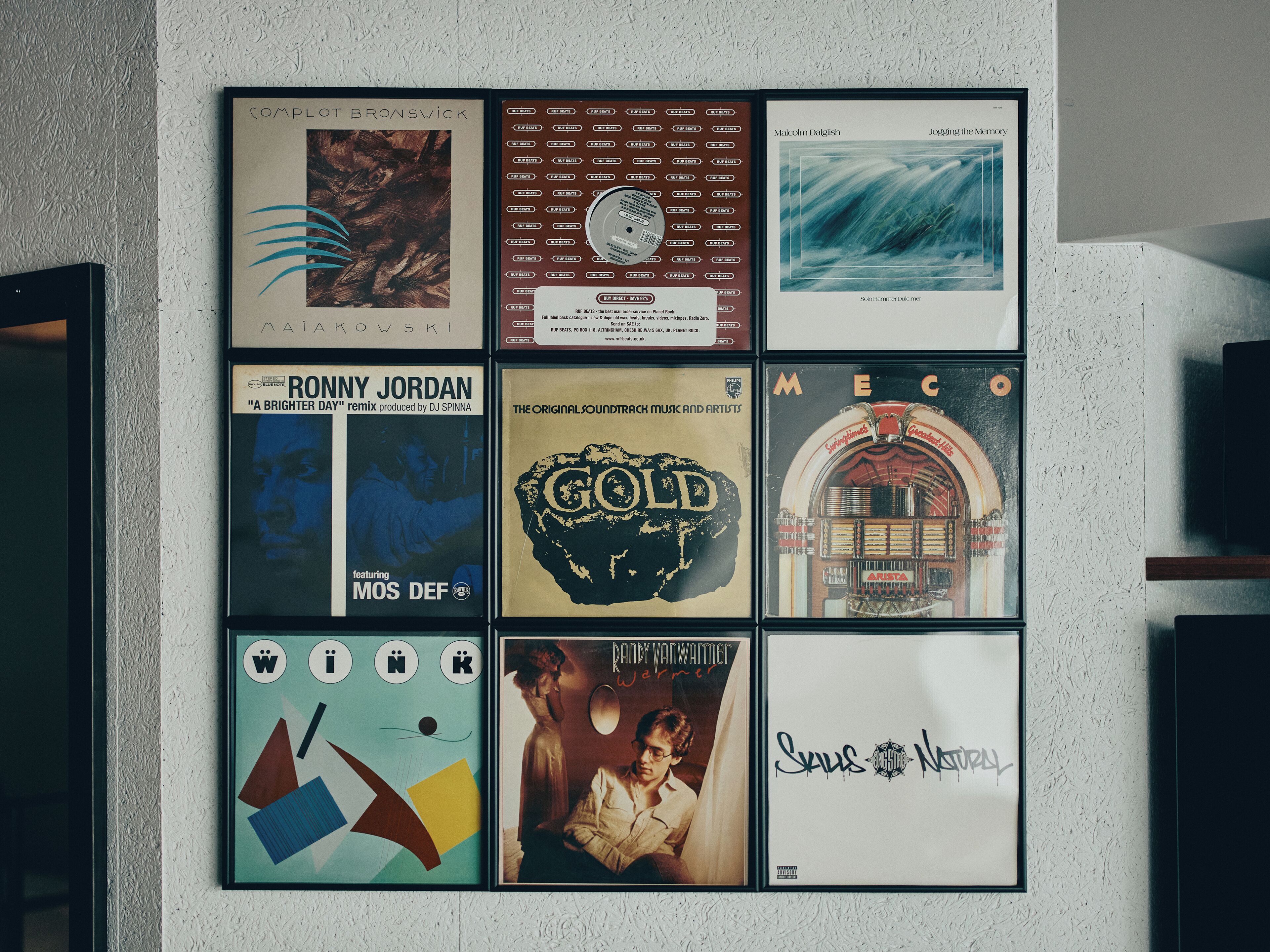 A wall with framed album covers.