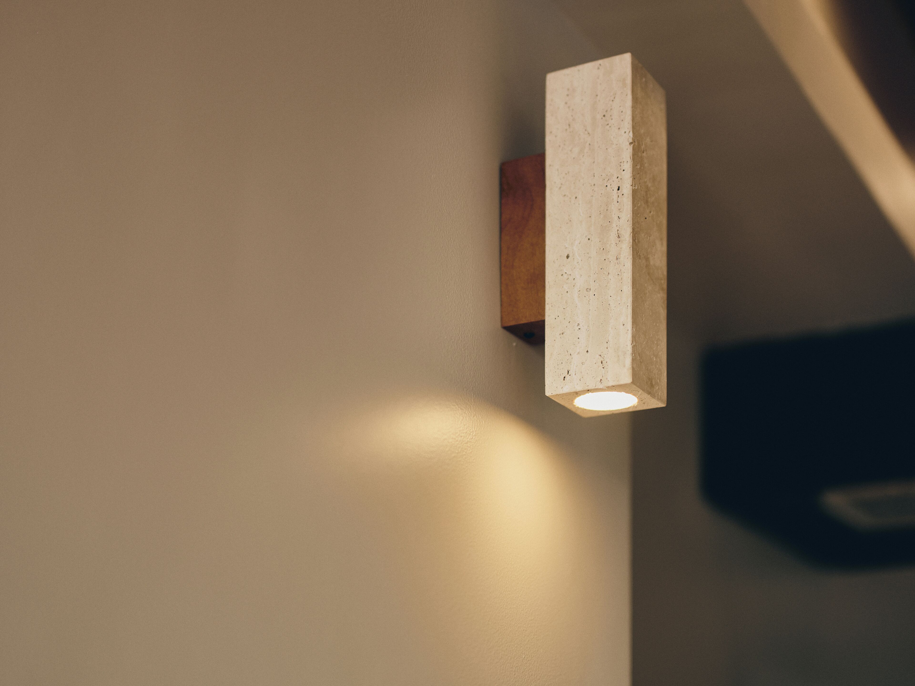 A modern light fixture mounted on a wall.