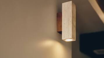 A modern light fixture mounted on a wall.