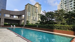 A swimming pool with a tiled edge, surrounded by a brick walkway. - South of Market  (Taguig)