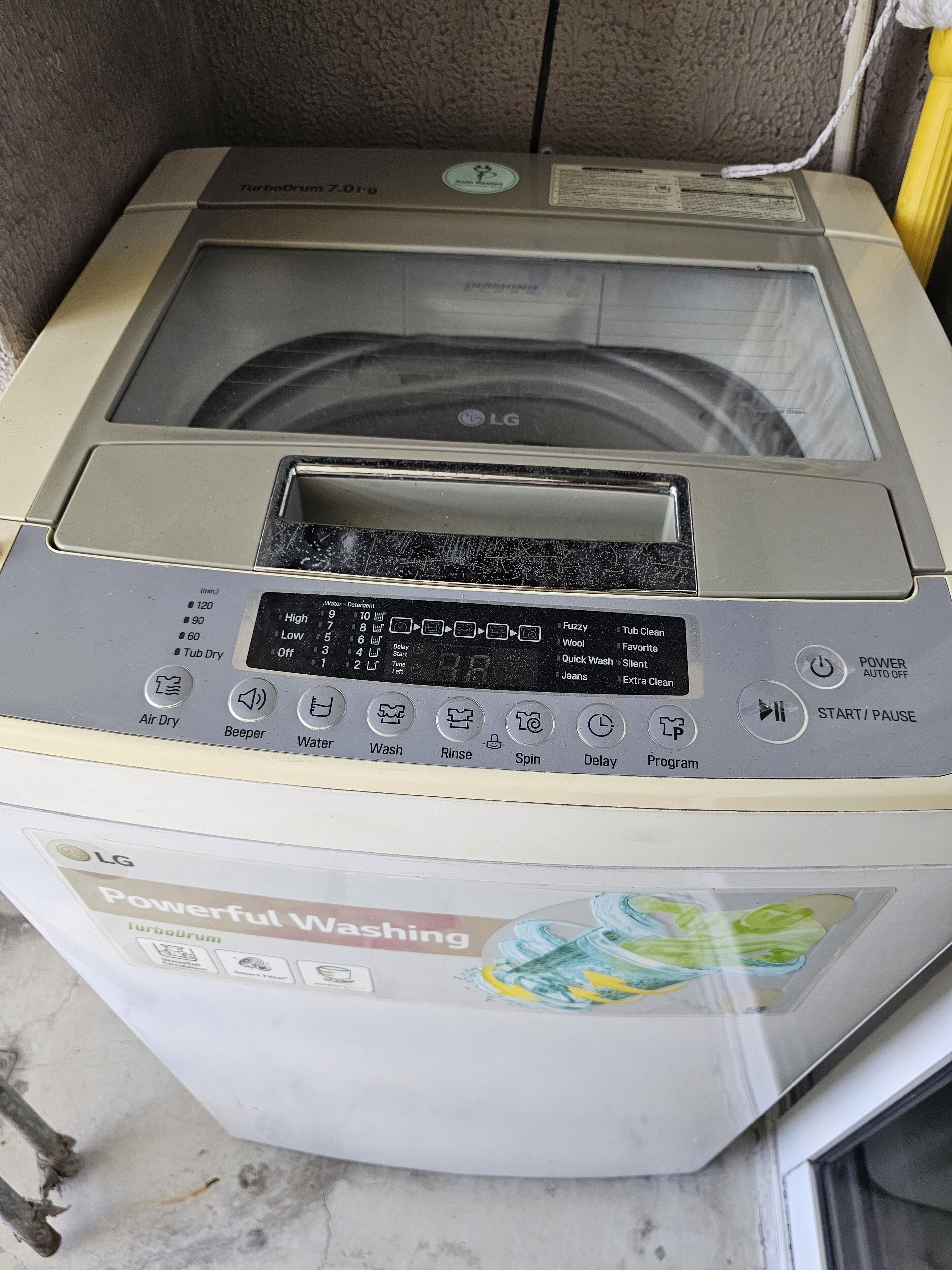 A TurboDrum washing machine with a digital display and multiple buttons for various wash settings.