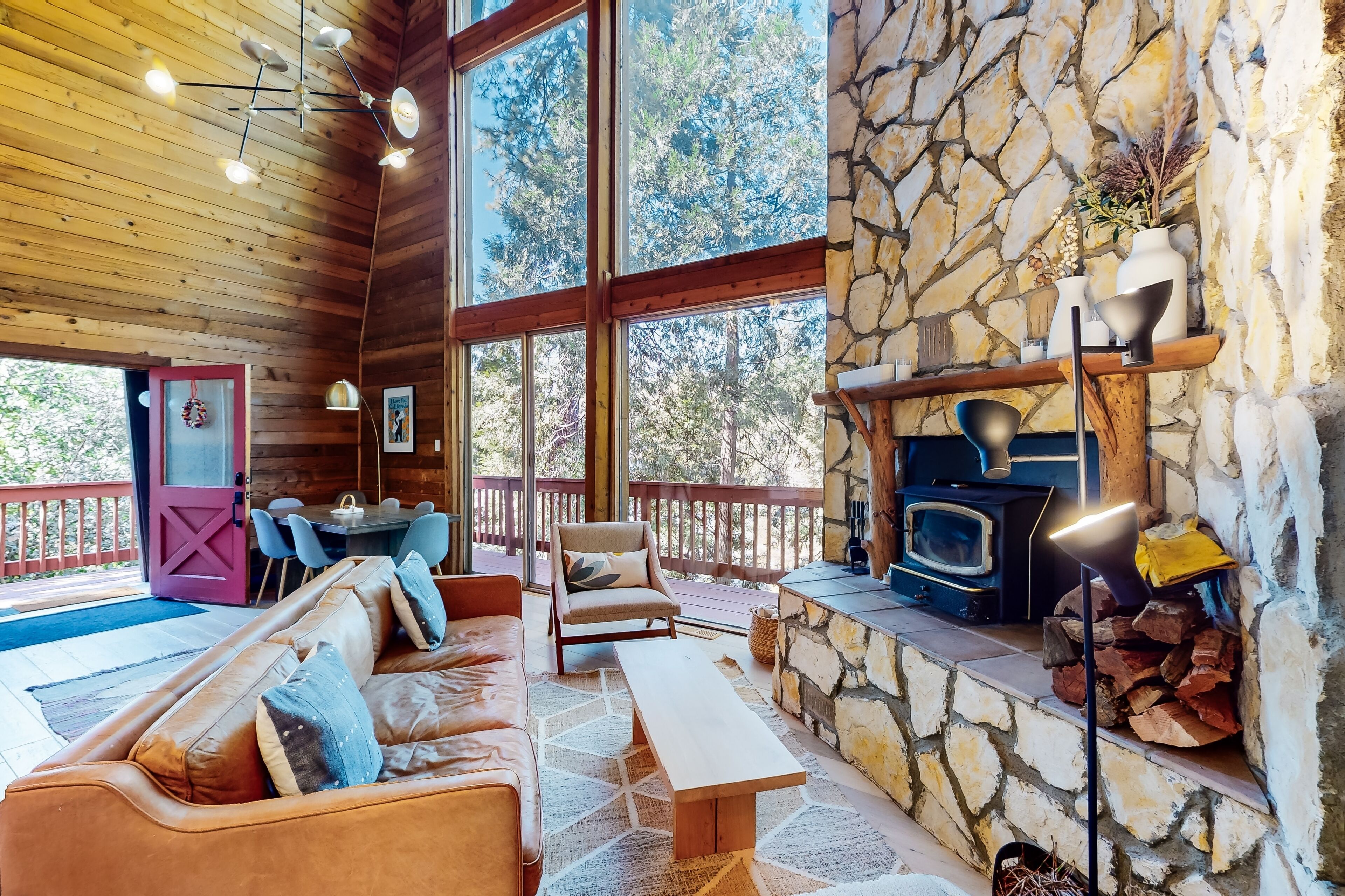 Two-story home with loft, fireplace, balcony, tree views, and patio